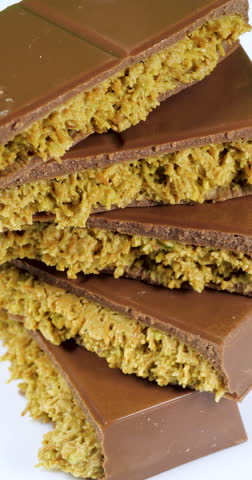 Trend Dubai Chocolate Bar with Green Kadayif Pistachio Paste and Peanut Butter Rotating on White Background