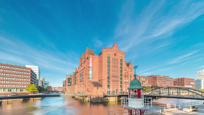 Famous old Speicherstadt in Hamburg timelapse hyperlapse featuring the International Maritime Museum, iconic brick buildings, arch bridges, canals and waterfront. A historic landmark in Germany
