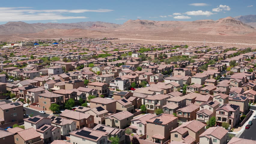 Aerial drone shot of Las Vegas suburban desert homes with sandstone mountains - Aerial Drone View