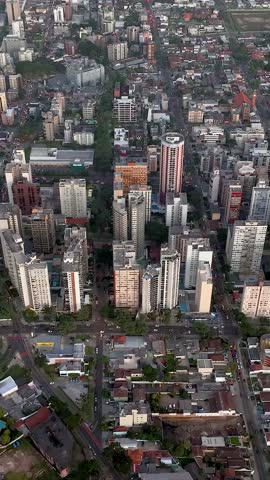 Curitiba in Parana, Brazil. Aerial View. Wonderful sunset with views of buildings and Tangua Park. Lake with reflection. Vertical video.