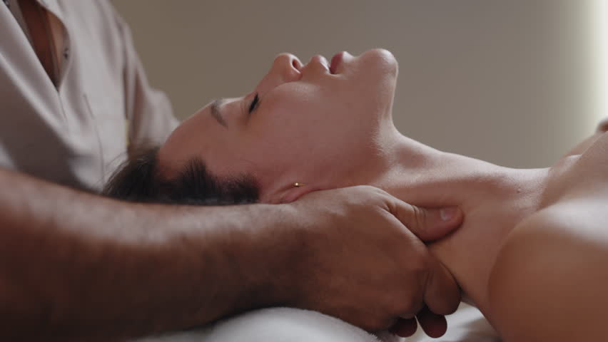 Woman receiving professional neck massage therapy