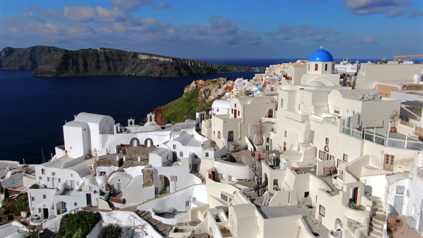 Experience Mykonos Greece stunning aerial views, with iconic white buildings and blue domes against the beautiful Aegean Sea, making its perfect destination for lovers of scenic beauty and exploration