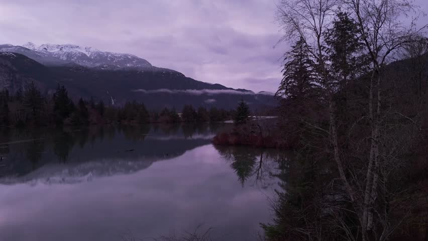Purple Dusk in Squamish Valley: Snow-Capped Mountains Reflected in Calm Lake