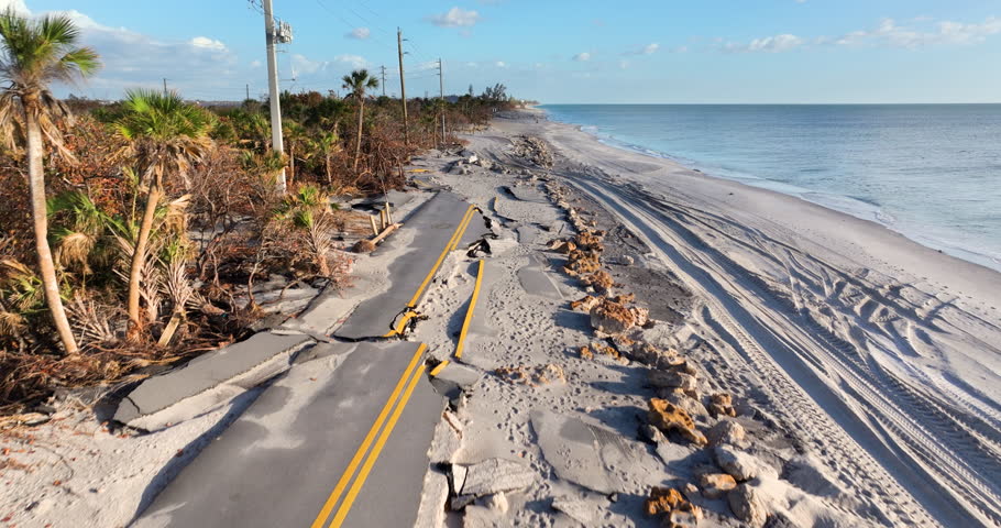 Hurricane storm surge destroyed waterfront road on ocean shore in Florida. Severe damage to transportation infrastructure