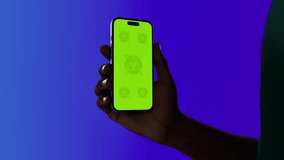 Black African-American middle aged male using smartphone with a blank green screen. Mobile app video mockup. Vertical phone orientation - Powered by Shutterstock - Get 15% off with code: PIKWIZARD15
