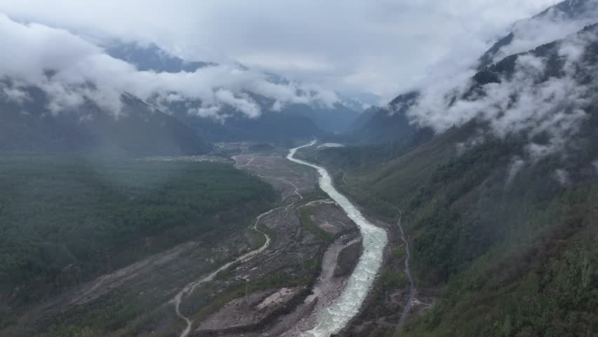Nyingchi, Tibet, China - 2nd April 2025 - aerial view of primary forests and rivers with clouds