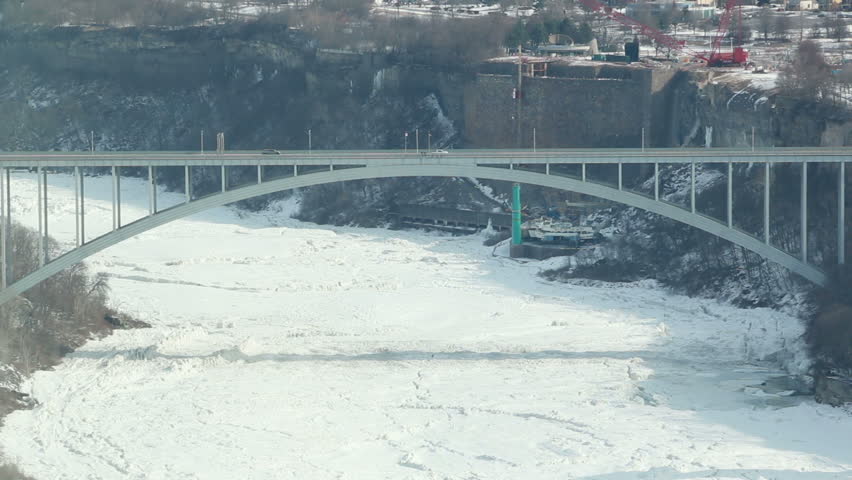 The Rainbow Bridge, connecting the American and Canadian sides of Niagara Falls, shot during a very cold winter in February, 2024. International border crossing between New York and Ontario.