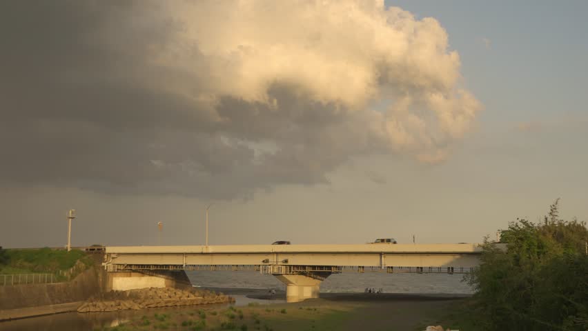 River Mouth and Highway at Sunset with Dramatic Clouds