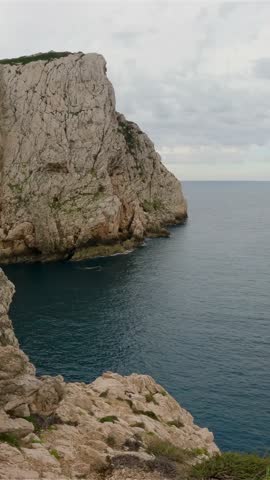 Rocky Coastline Meets Dark Blue Sea Under a Cloudy Sky in Europe