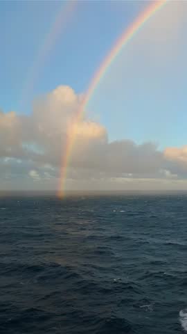Rainbow Arcing Over the Ocean in Europe on a Cloudy Day