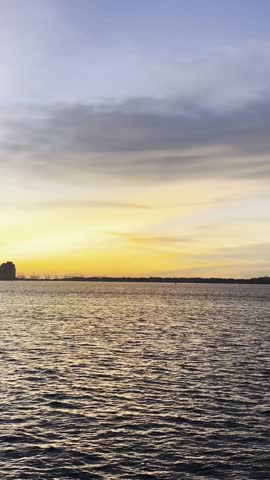 Golden Sunset with City Skyline Silhouette over Water in Singapore