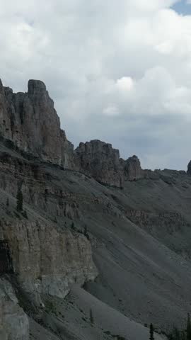 Rocky Mountain Range Under Cloudy Sky: A Vertical Video of Nature