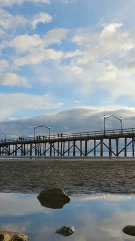 People Enjoying a Walk on the White Rock Pier in British Columbia, Canada