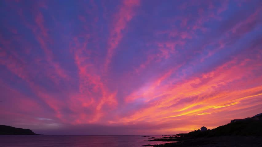 Vibrant Sunset Hues Over Coastal Horizon