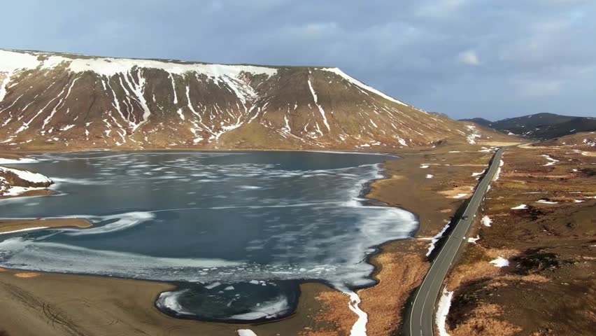 Aerial View of Frozen Lake and Mountain Landscape in Spring