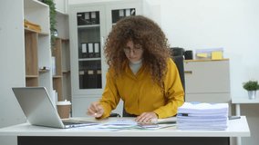 Confident Russian businesswoman sits indoors at her desk, dressed in formal attire,  paperwork and planning. Stylish and efficient, she manages tasks, notes ideas, and leads with professionalism. - Powered by Shutterstock - Get 15% off with code: PIKWIZARD15