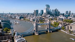 Aerial time lapse view of the City and Tower Bridge in London, England, during a sunny summer day with river boat traffic and people crowds - Powered by Shutterstock - Get 15% off with code: PIKWIZARD15
