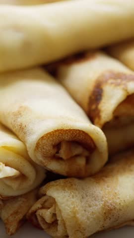 A Delightfully Delicious Stack of Rolled Crepes, Perfect for Enjoying as a Sweet Dessert Treat