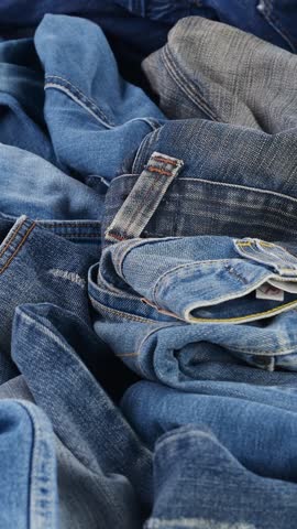 Fast fashion denim pollution. Old jeans landfill crisis