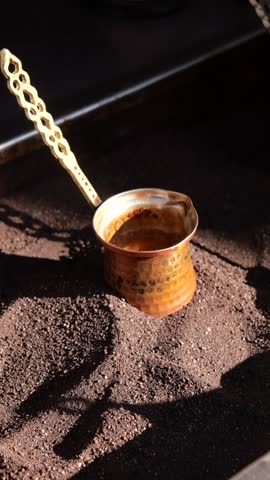 top view of making traditional turkish coffee on sand 
