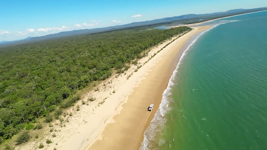 LARC tour vehicle travels along Eurimbula national park coastline, drone aerial view, tourist travel activity, amphibious army duck on way to Bustard Head Lighthouse