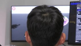 A Chinese boy is watching a children's science education video. - Powered by Shutterstock - Get 15% off with code: PIKWIZARD15