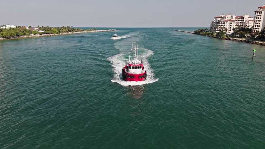 Boat tug at sea. Aerial footage of tow-boat transportation. Tugboat sailing at sea top view. Sea transport. Motor boat. Boating and tugging. Tugboat sea transportation