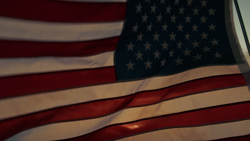 American flag waving against the light