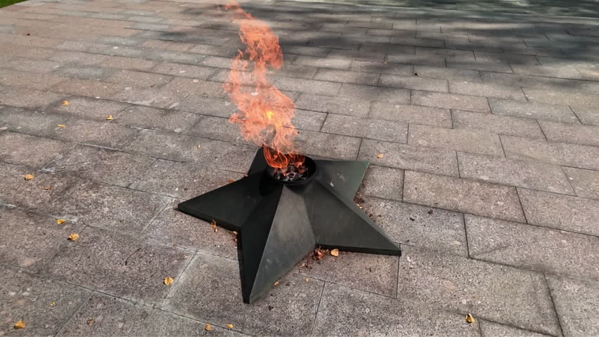 Eternal flame burns with fire outdoors.