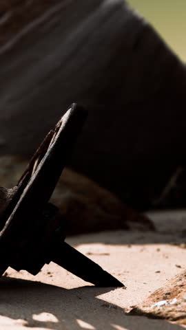 Old wooden cart wheel at sand beach