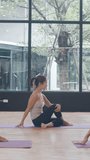 Vertical Screen : Young Asian sporty attractive people practicing yoga lesson with instructor. Asia group of women exercising healthy lifestyle in fitness studio. Sport activity ballet dancing class. - Powered by Shutterstock - Get 15% off with code: PIKWIZARD15
