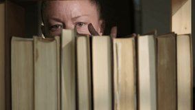 Woman reader choosing and taking book from bookshelf close-up - Powered by Shutterstock - Get 15% off with code: PIKWIZARD15
