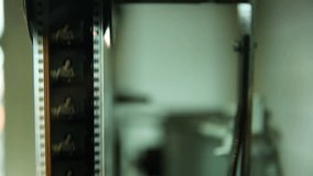  Macro shot: Vintage film strips glide through intricate projector or scanner rollers. Evokes cinema nostalgia and analog processes. Perfect for archival, retro, or filmmaking themes. - Powered by Shutterstock - Get 15% off with code: PIKWIZARD15