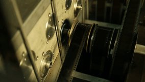  Macro shot: Vintage film strips glide through intricate projector or scanner rollers. Evokes cinema nostalgia and analog processes. Perfect for archival, retro, or filmmaking themes. - Powered by Shutterstock - Get 15% off with code: PIKWIZARD15
