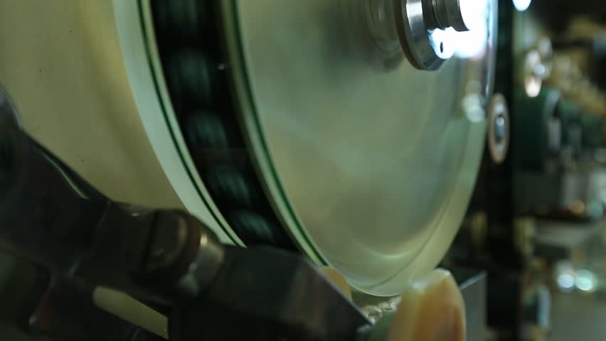  Macro shot: Vintage film strips glide through intricate projector or scanner rollers. Evokes cinema nostalgia and analog processes. Perfect for archival, retro, or filmmaking themes.