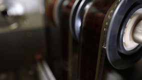  Macro shot: Vintage film strips glide through intricate projector or scanner rollers. Evokes cinema nostalgia and analog processes. Perfect for archival, retro, or filmmaking themes. - Powered by Shutterstock - Get 15% off with code: PIKWIZARD15