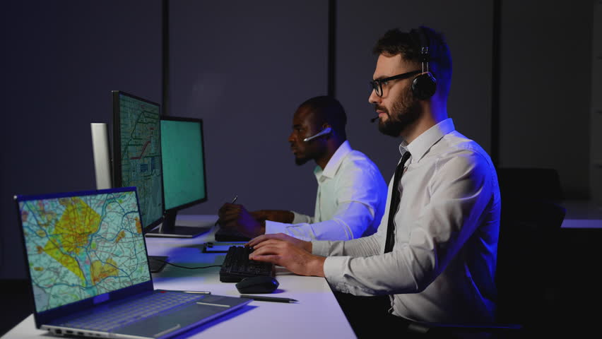 Two dispatchers monitoring live GPS tracking system
