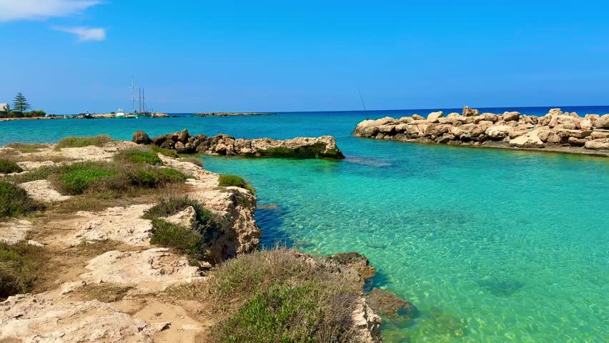 Picturesque beach, waves crashing on the sandy shore. Sea waves beat against the rocks. Cyprus Island, Mediterranean Sea.
