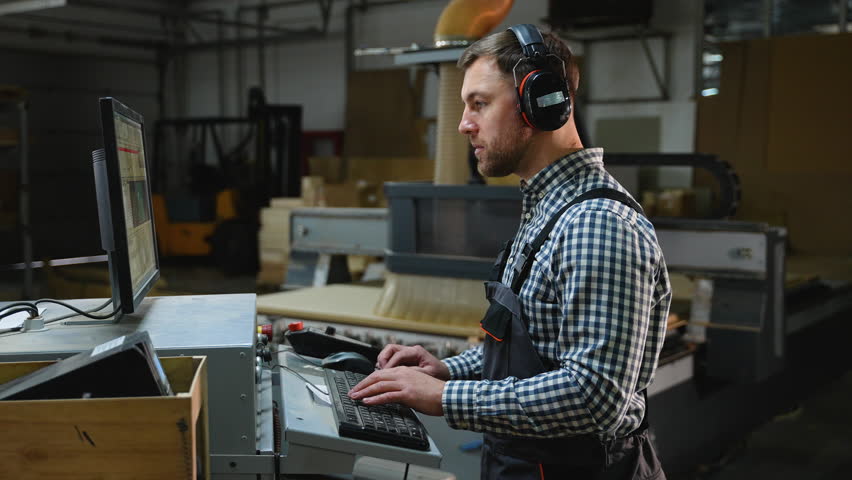 CNC Operator Working with Cutting Machine Software