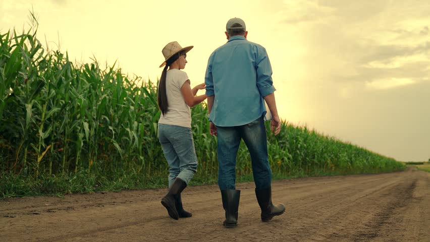 Farmers man woman with digital tablet inspect corn field harvest. Digital technologies agriculture. Business people grow corn. Teamwork of farmers in corn field. Agricultural industry concept. Workers