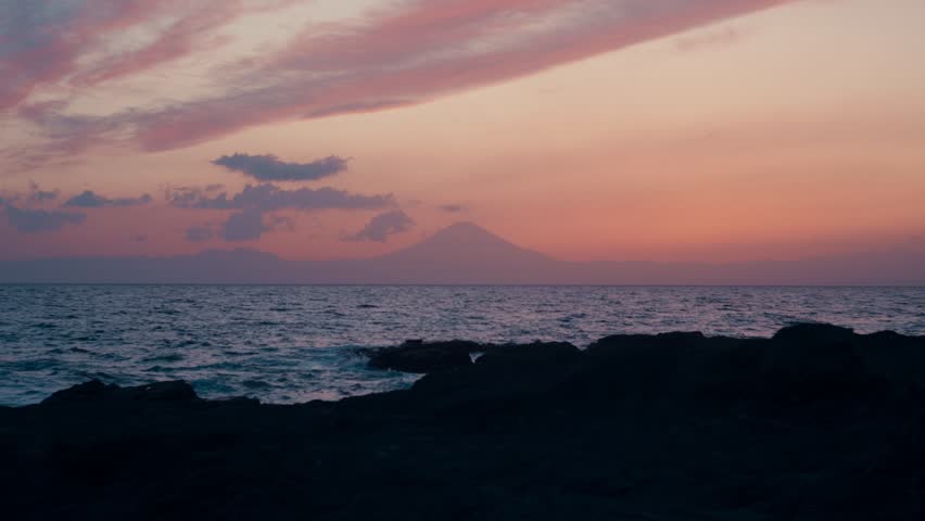 Blue Hour Tranquility at Japanese Coastal Rocks
Still ocean meets rock and sky in a peaceful sunset scene on Japan’s western coast.