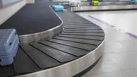Suitcases travel along airport baggage carousel while man identifies and lifts luggage. Travelers waiting moving bags, flight arrivals continue, tourism flow, luggage handling, post journey reunions - Powered by Shutterstock - Get 15% off with code: PIKWIZARD15