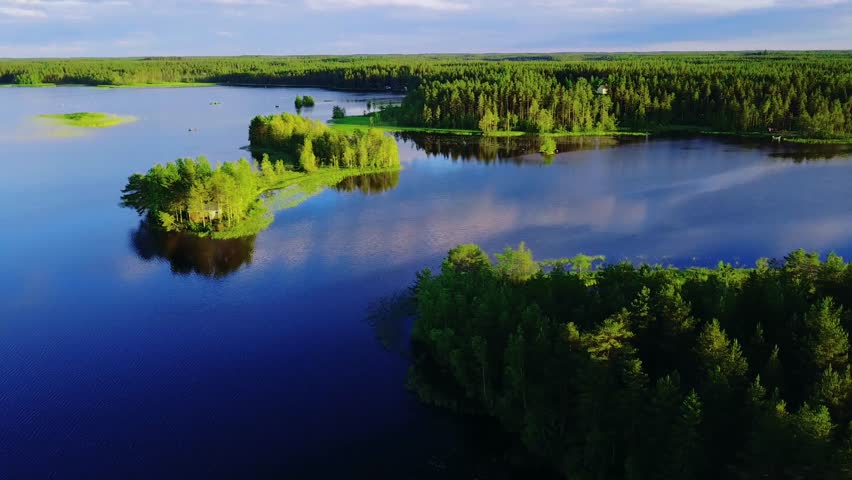 Aerial drone view of blue water lakes with green summer woods in Finland