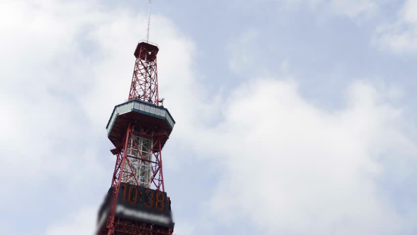 Sapporo TV Tower on a cloudy day in Hokkaido, Japan. A symbolic landmark surrounded by city buildings and muted skies.