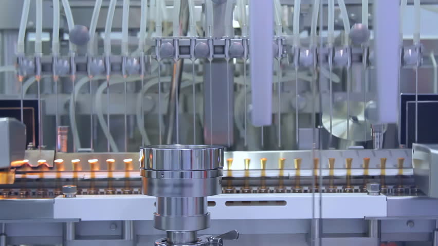 Pharmaceutical manufacturing processing by Filling liquid chemical medicine in bottles. filling making process in a plastic transparent bottle manufacturing factory.