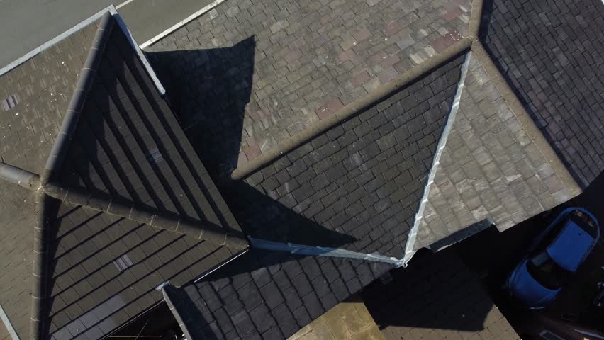 Rooftop inspection aerial view inspecting damage and repair of property real estate for homeowner
