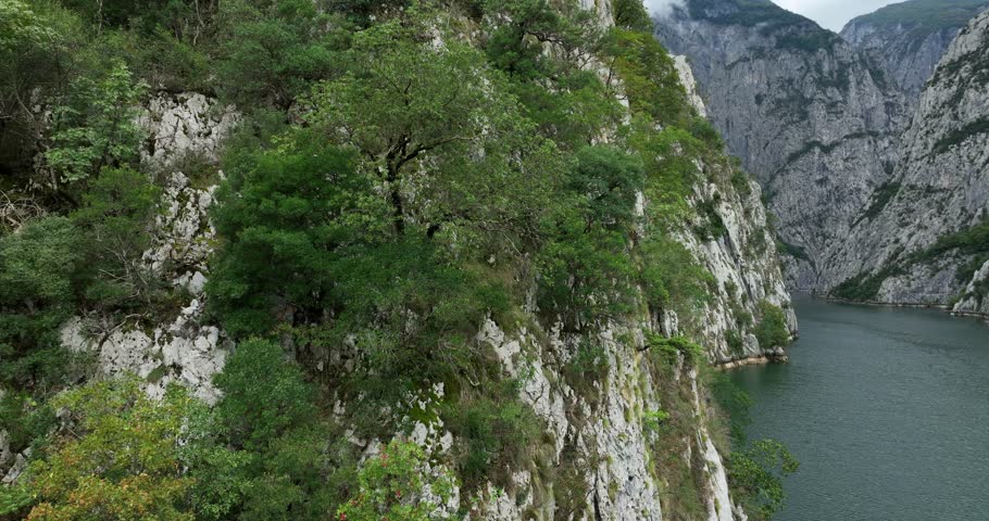 Drone shot of lake Komani limestone cliffs, narrow canyons carved by Drini River, Albania