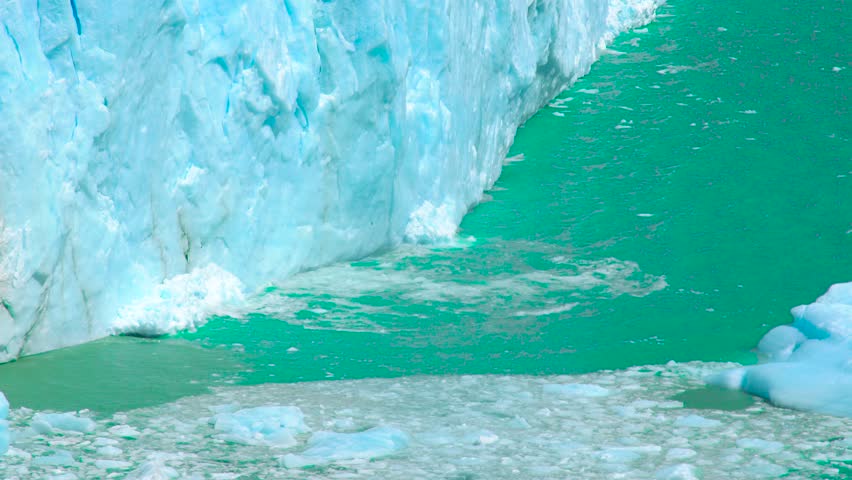 Perito Moreno Glacier in Argentina showcases large ice formations and turquoise waters, surrounded by fragmented ice floes.
