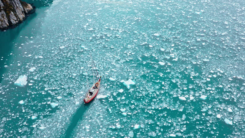 Aerial View Of A Fishing Boat Cruising Over Frozen Waterways Of Beagle Channel In South America.
