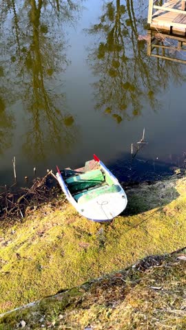 canal, pond, park, boat on the river at the pier, old boat